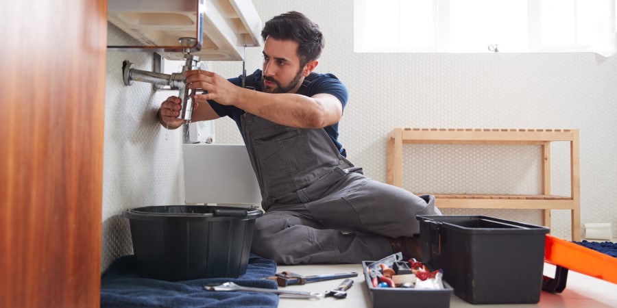 Plumber fixing sink